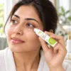 Applying Under Eye Roll On Serum Woman applying Under Eye Roll On Serum beneath her eye with the cooling rollerball